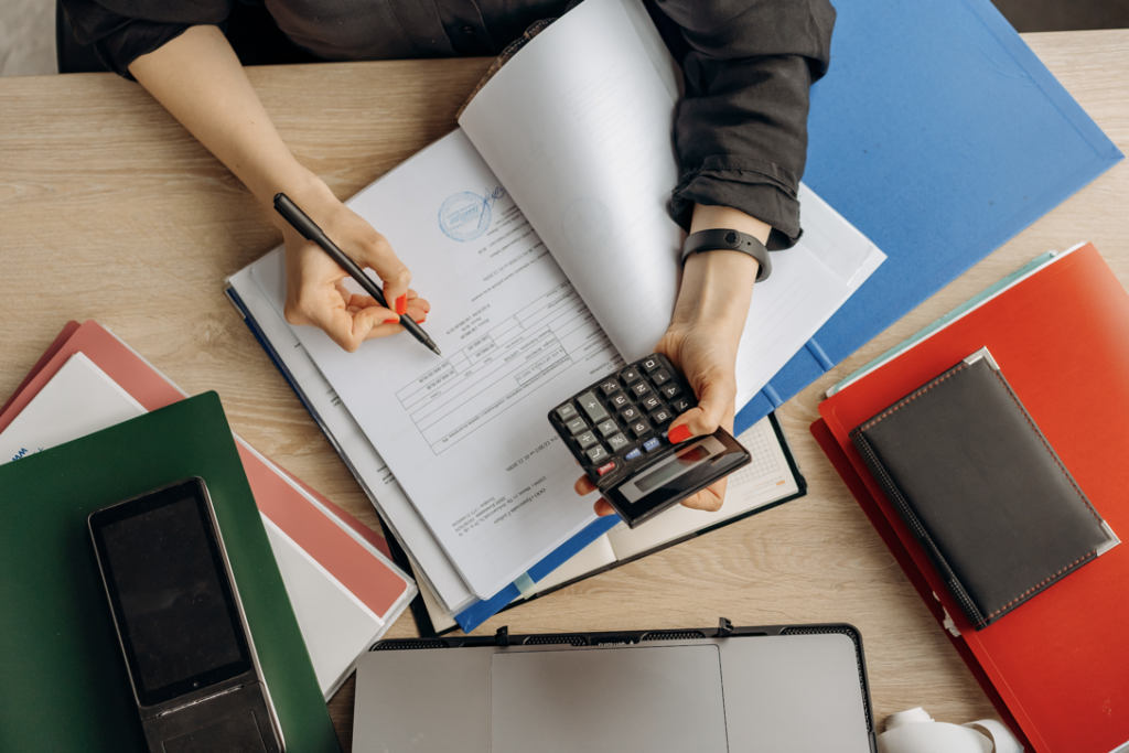 Accountant examining documents calculator