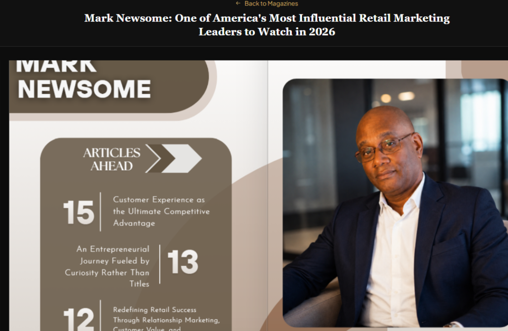 A screenshot image of Mark Newsome, aka Mr. Marketing sitting in a chair. With a blue blazer on.